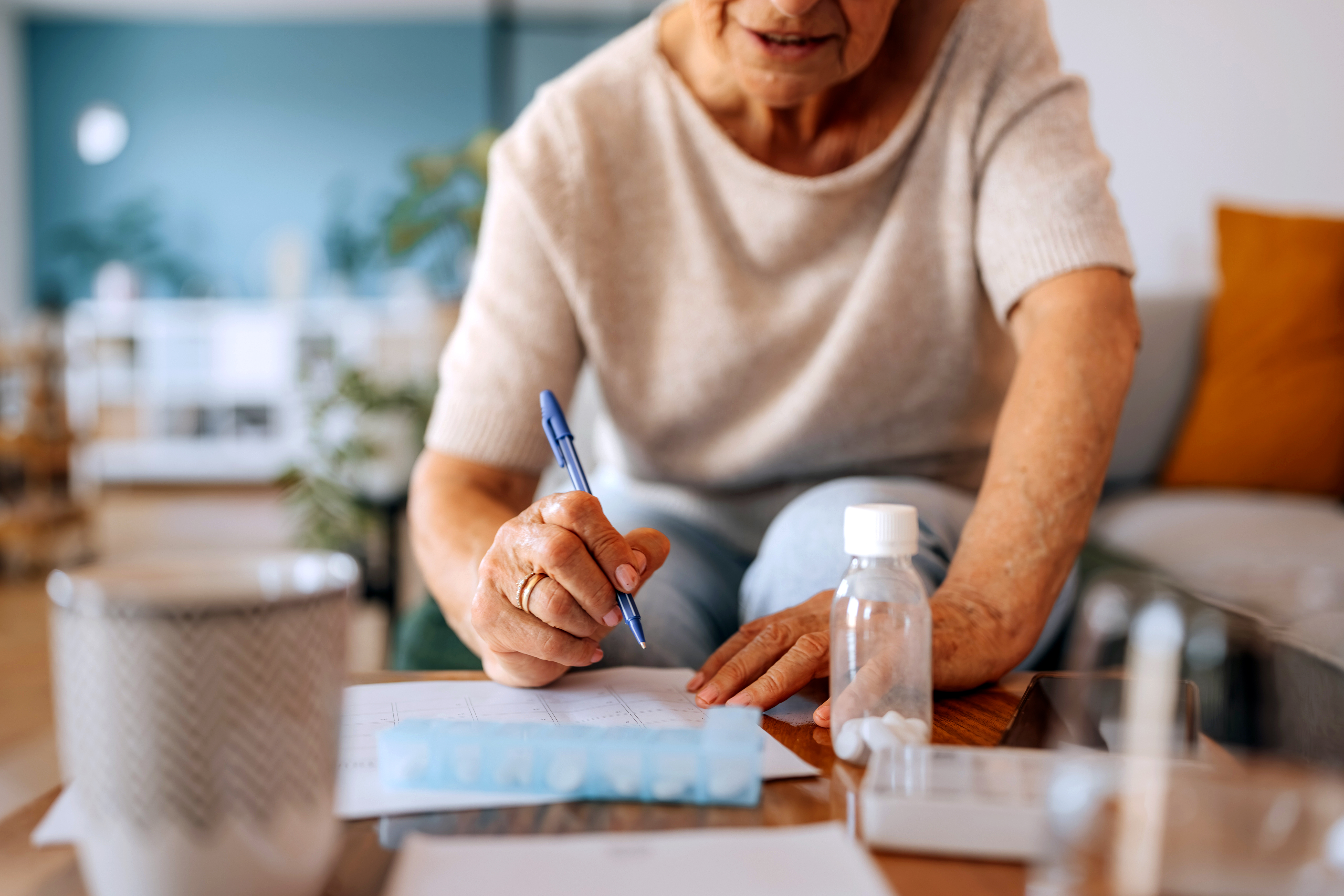 Patient writing medication list Patient writing medication list